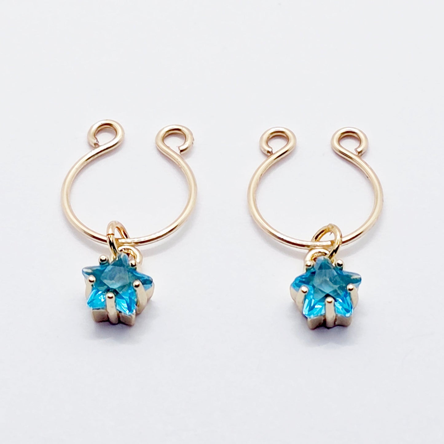 Pair of gold earrings with blue gemstones