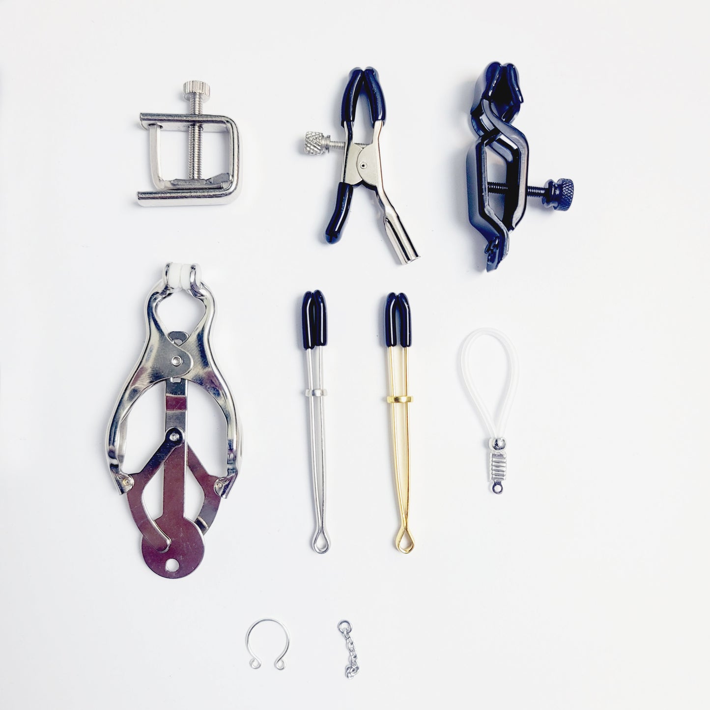 Gold Tri circle necklace attached to nipple nooses or feel the sting with one of our five types of nipple clamps.