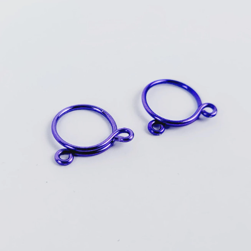 Two purple non-piercing nipple rings displayed against a white background.