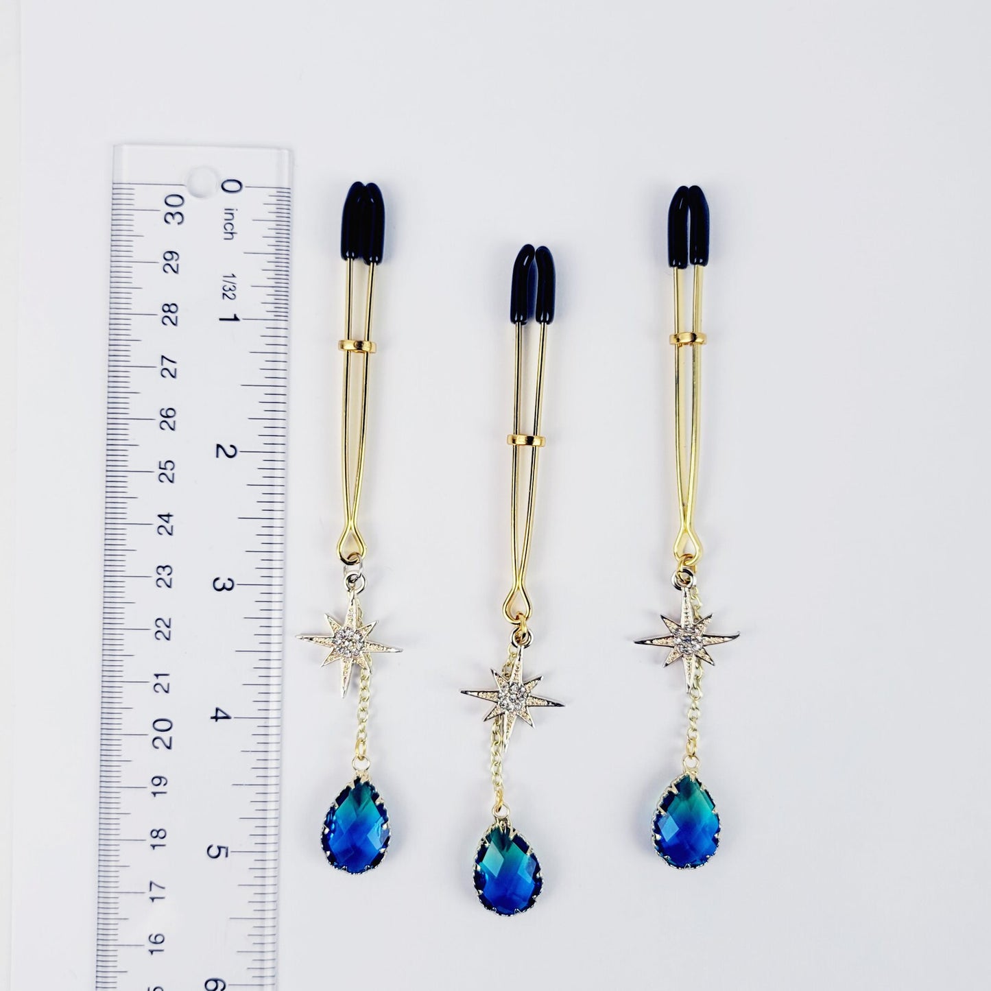 Gold Tweezer Clamp with Star and Blue Crystal