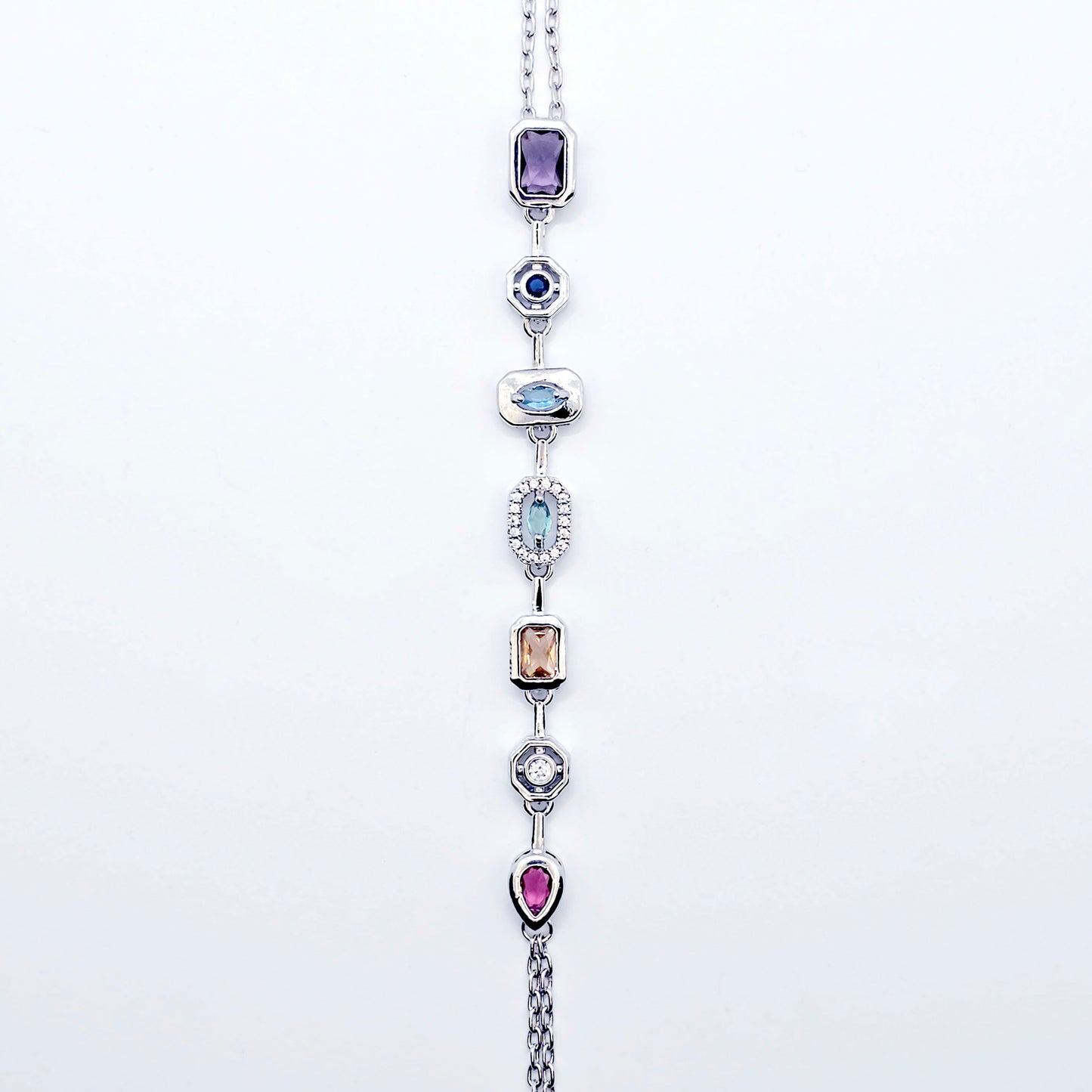 Platinum Necklace with Nipple Chains and Gemstones on a mannequin against a white background.