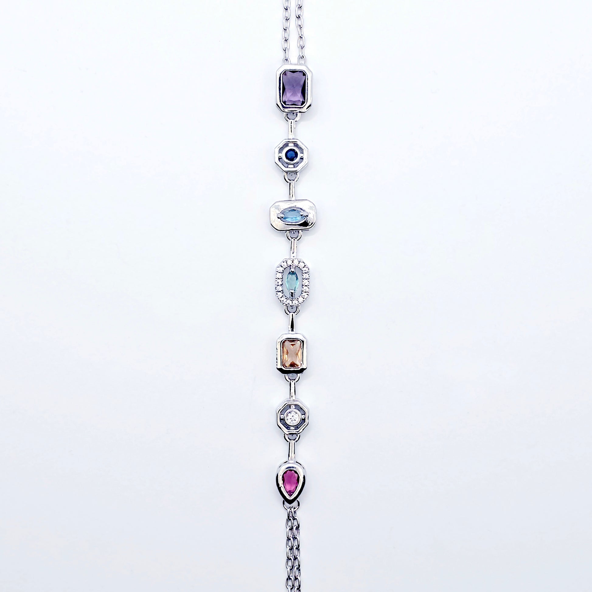 Platinum Necklace with Nipple Chains and Gemstones on a mannequin against a white background.