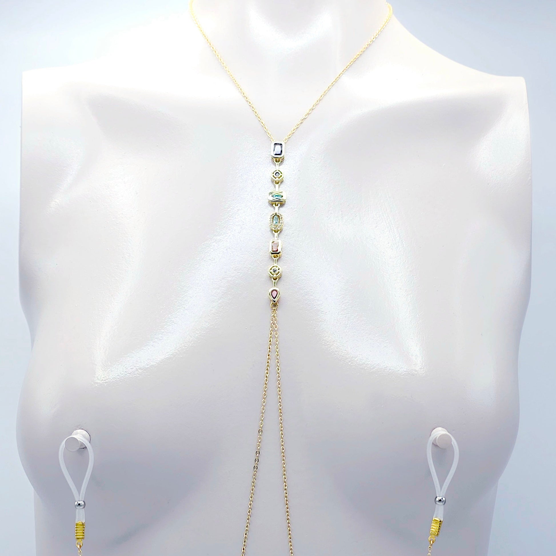 Gold body chain on a mannequin against a white background