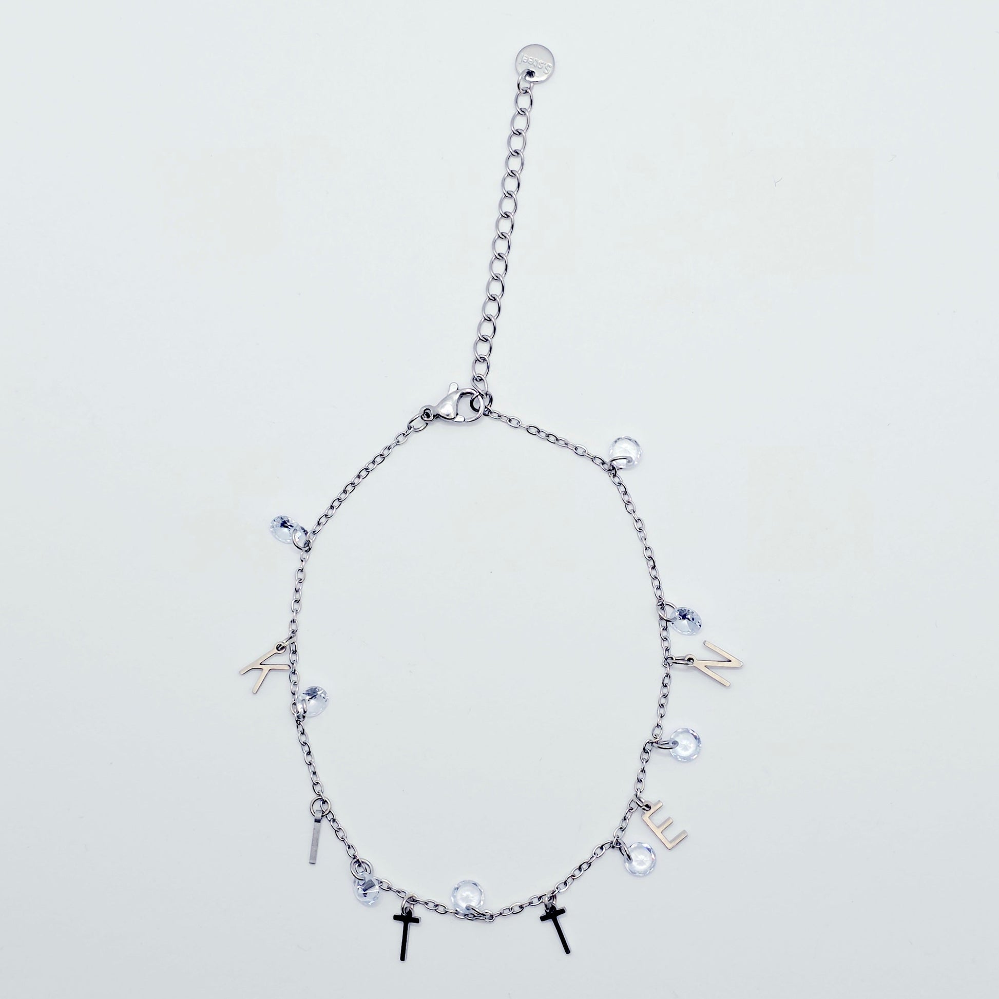 Silver bracelet with various charms on a light gray background