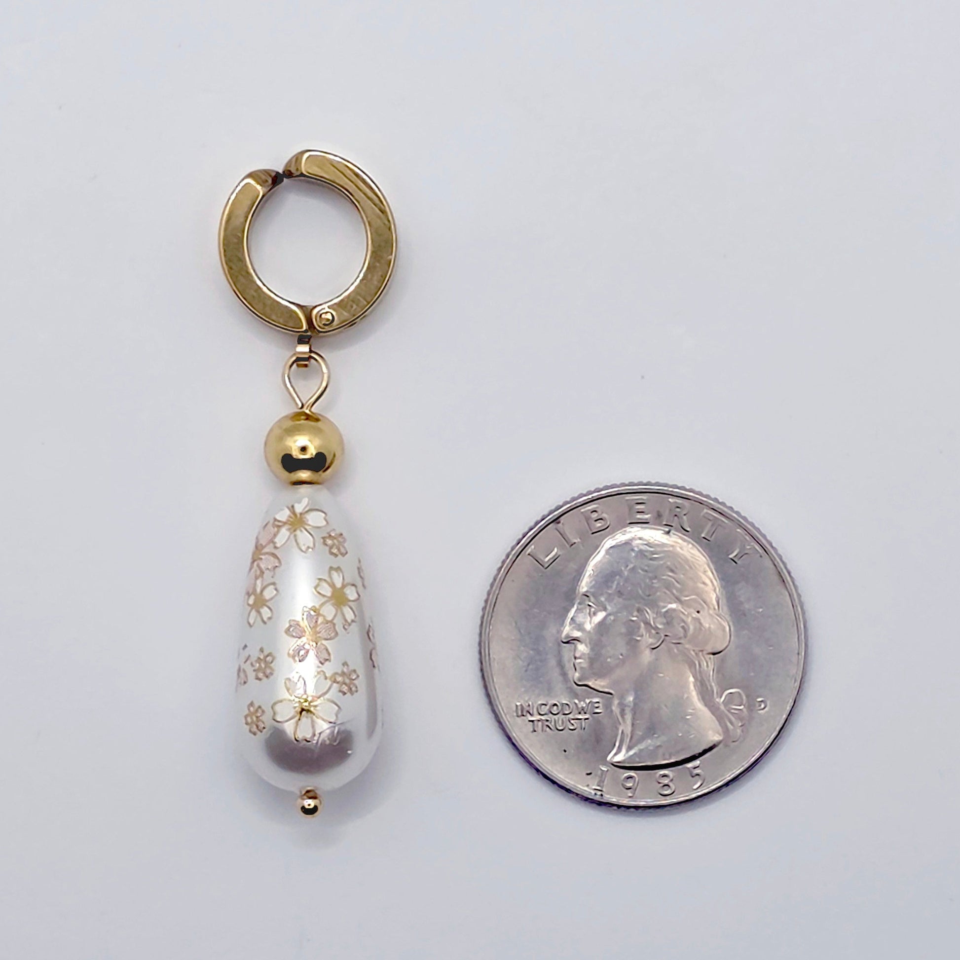 Gold VCH Clip with Painted Pearl  next to a quarter
