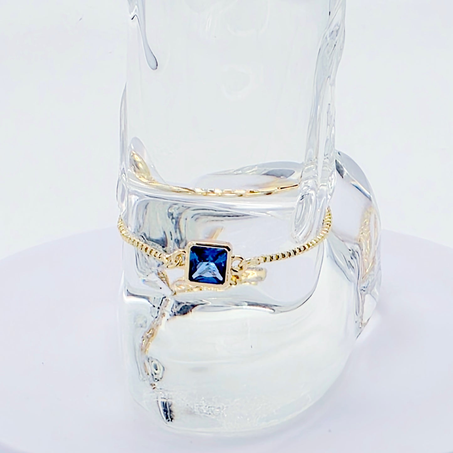 18k Gold Penis Noose Bracelet with Bright Blue Gem.