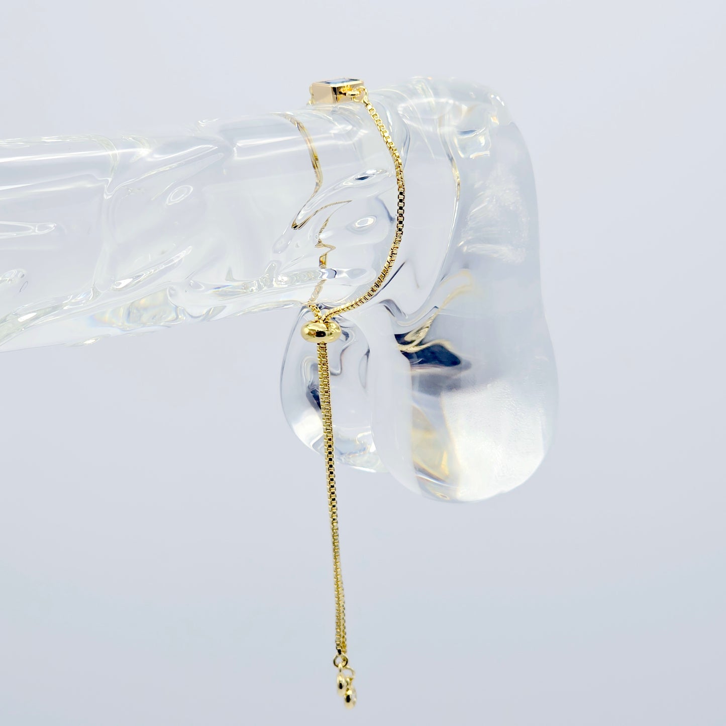 18k Gold Penis Noose Bracelet with Bright Blue Gem.