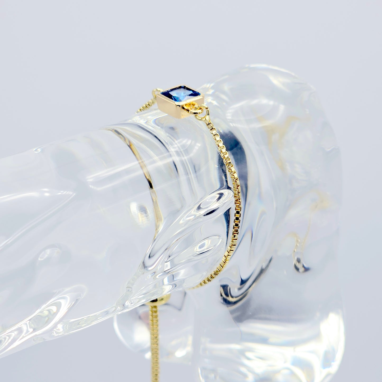 18k Gold Penis Noose Bracelet with Bright Blue Gem.
