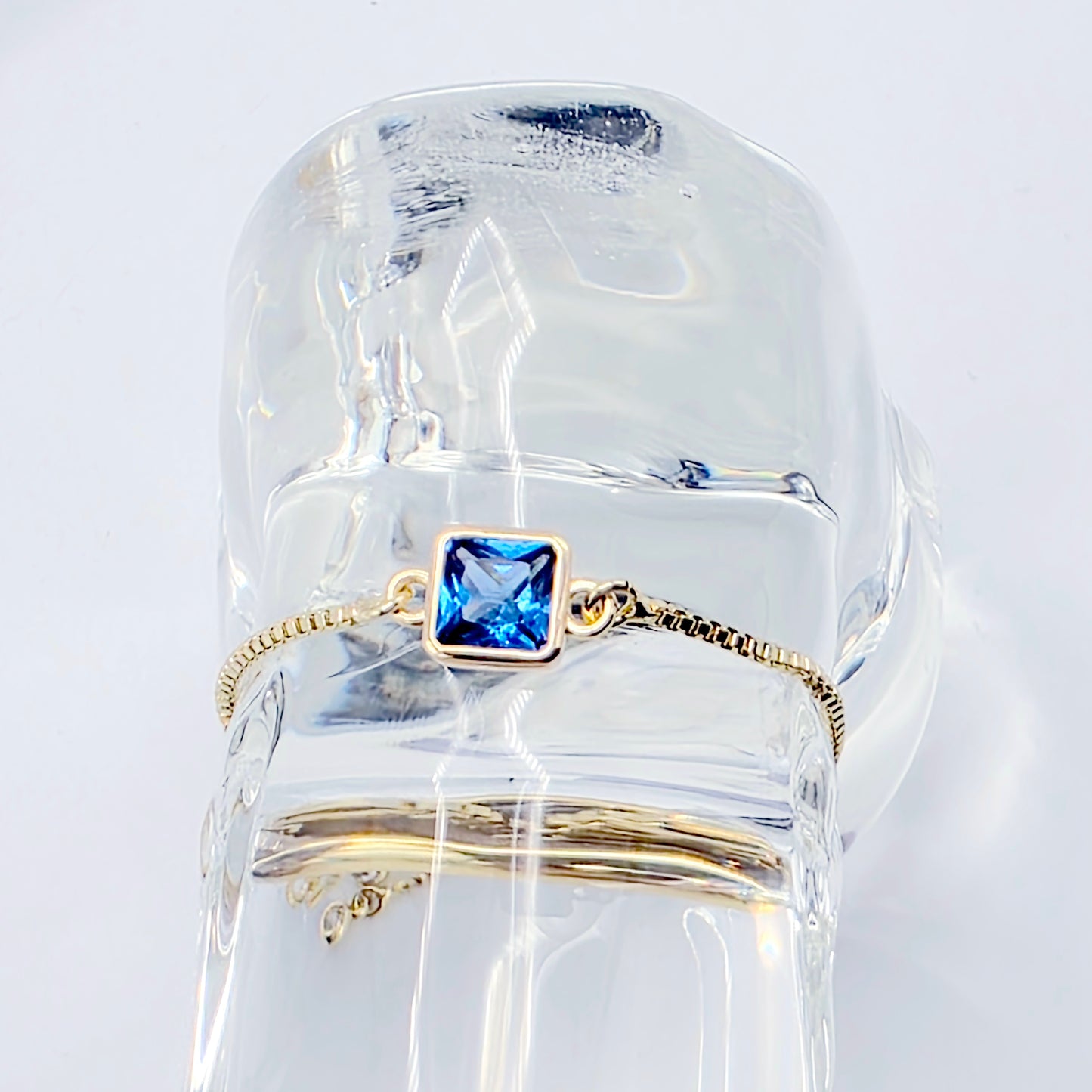 18k Gold Penis Noose Bracelet with Bright Blue Gem.