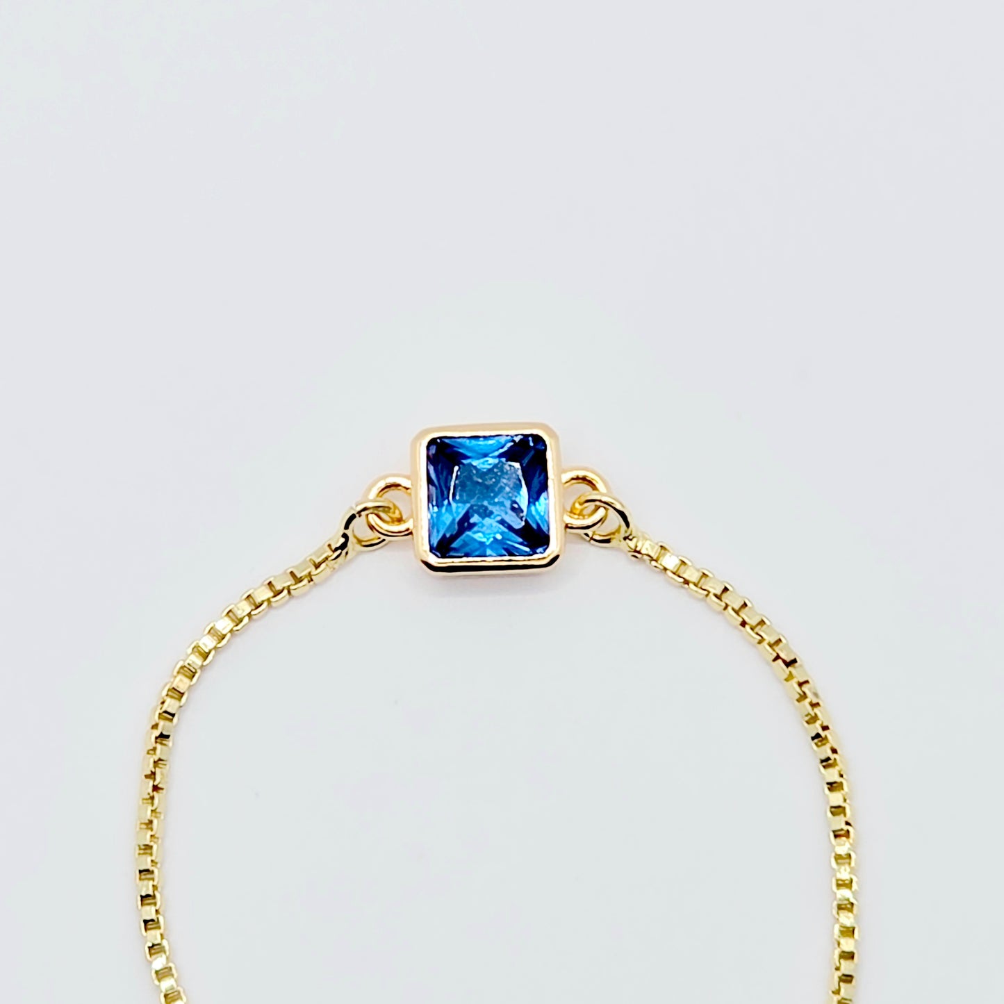 18k Gold Penis Noose Bracelet with Bright Blue Gem.
