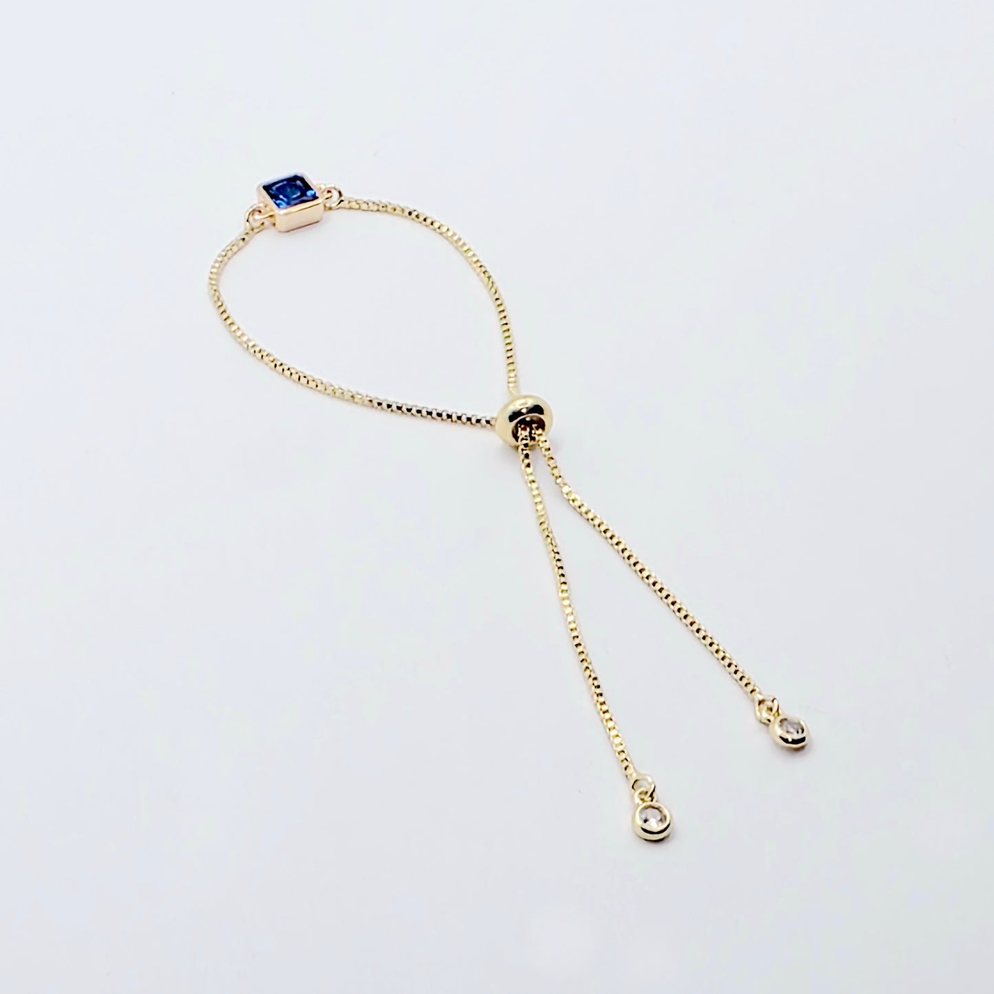 18k Gold Penis Noose Bracelet with Bright Blue Gem.