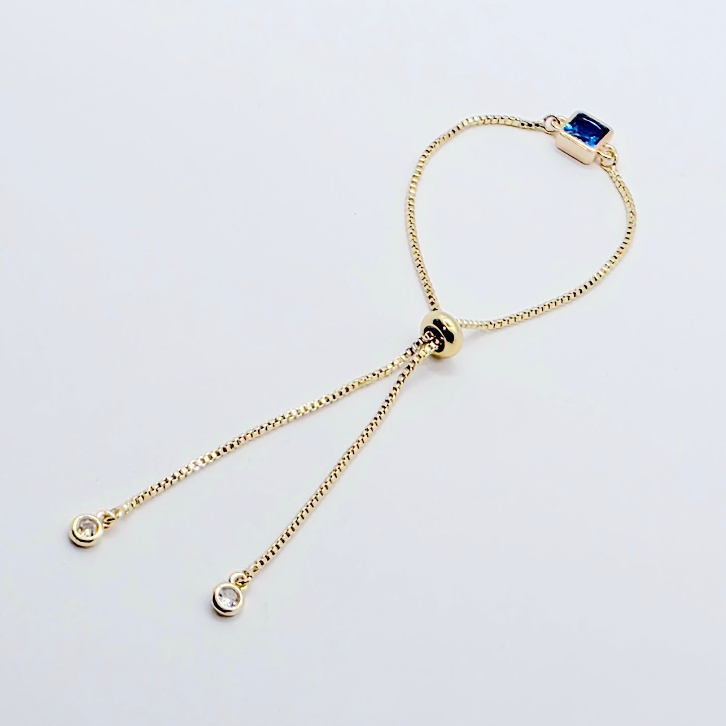 18k Gold Penis Noose Bracelet with Bright Blue Gem.