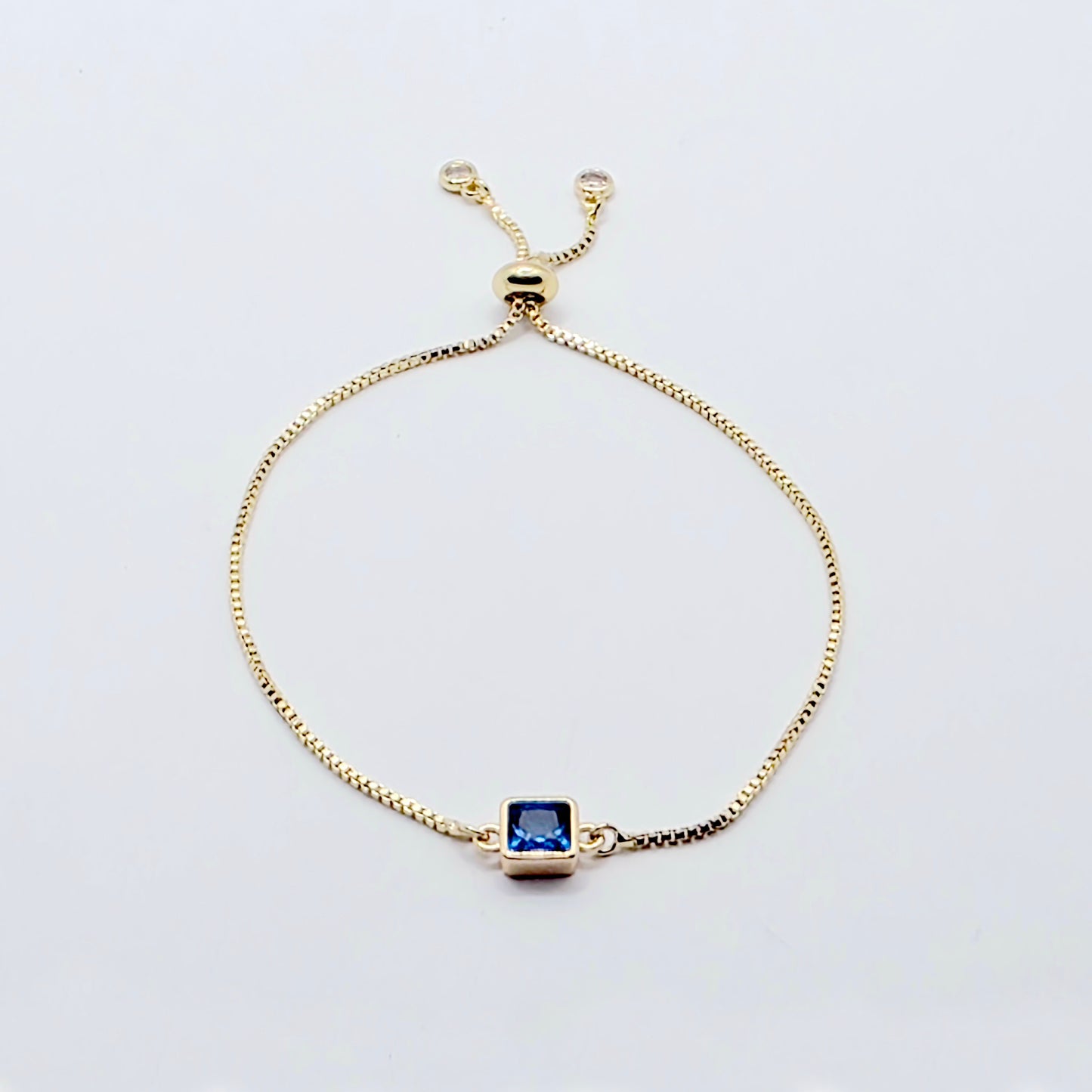 18k Gold Penis Noose Bracelet with Bright Blue Gem.