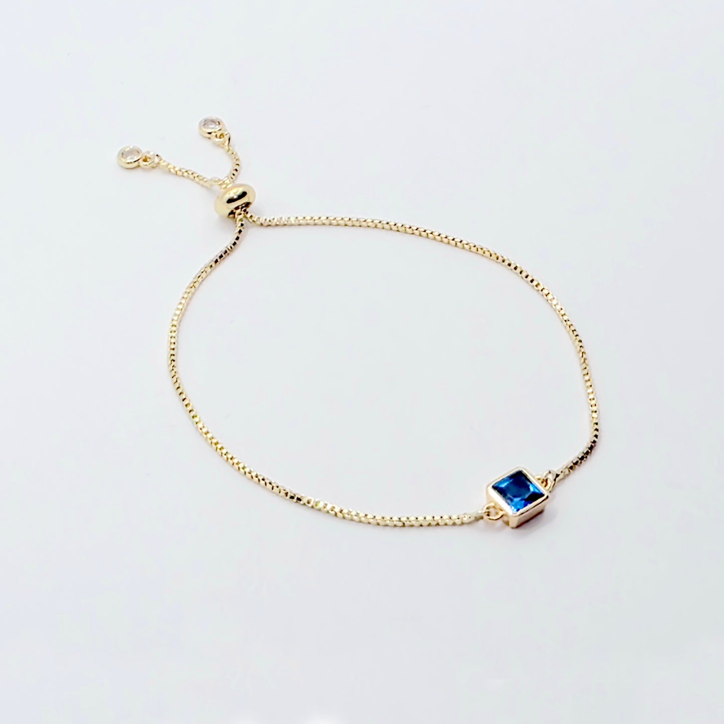 18k Gold Penis Noose Bracelet with Bright Blue Gem.
