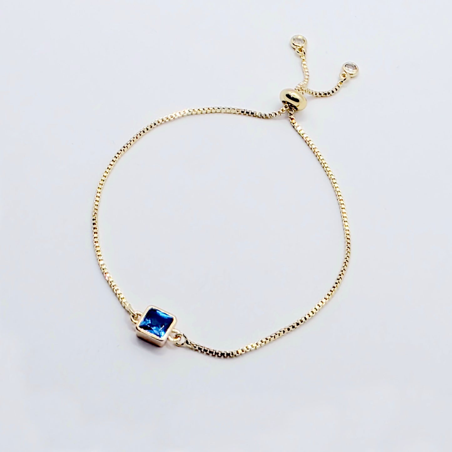 18k Gold Penis Noose Bracelet with Bright Blue Gem.