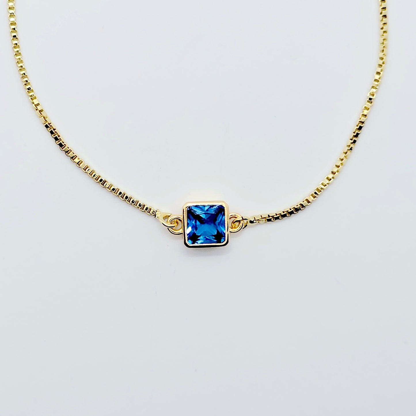 18k Gold Penis Noose Bracelet with Bright Blue Gem.