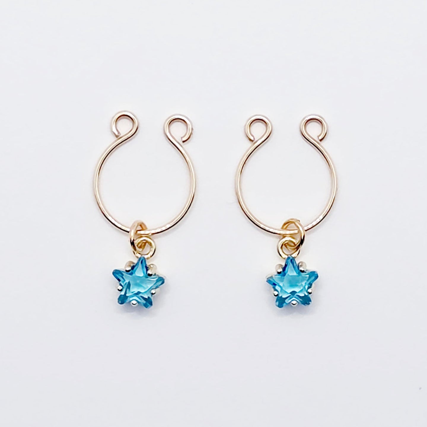 Pair of gold earrings with blue star-shaped stones