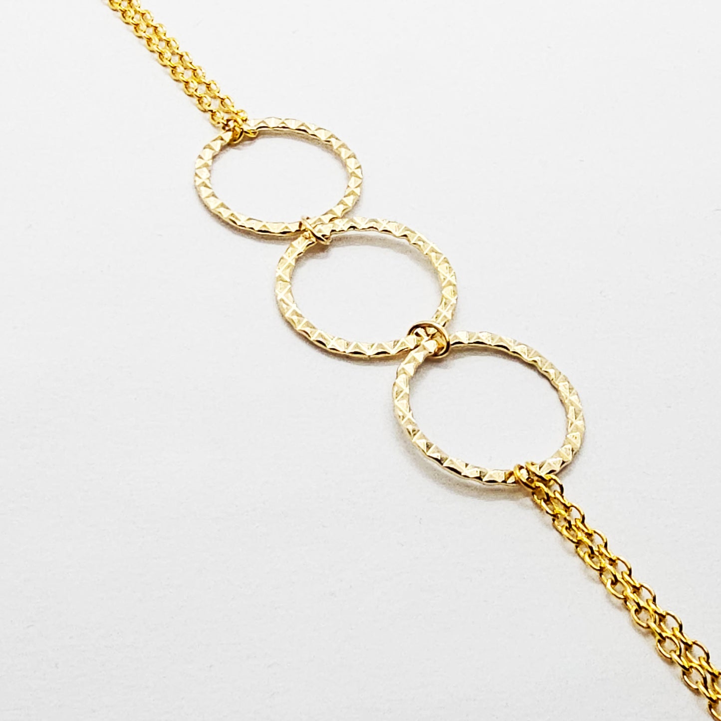 Gold Tri circle necklace attached to nipple nooses or feel the sting with one of our five types of nipple clamps.