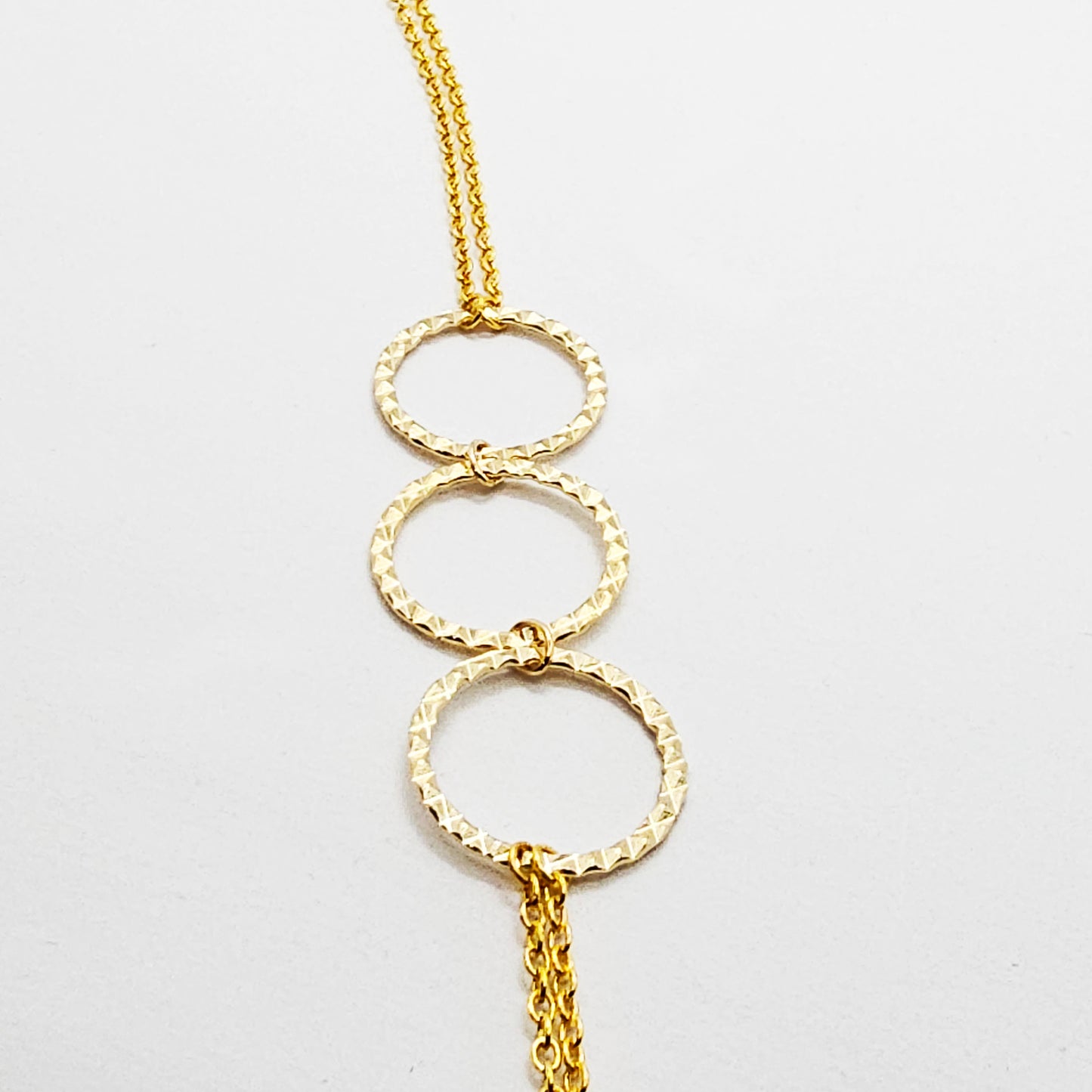 Gold Tri circle necklace attached to nipple nooses or feel the sting with one of our five types of nipple clamps.