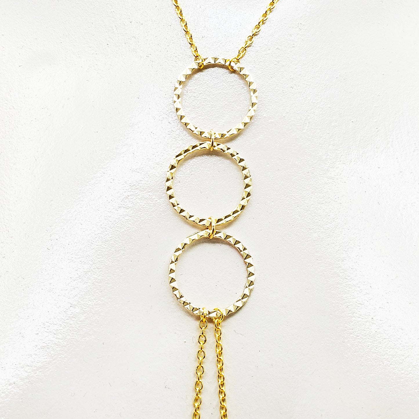 Gold Tri circle necklace attached to nipple nooses or feel the sting with one of our five types of nipple clamps.