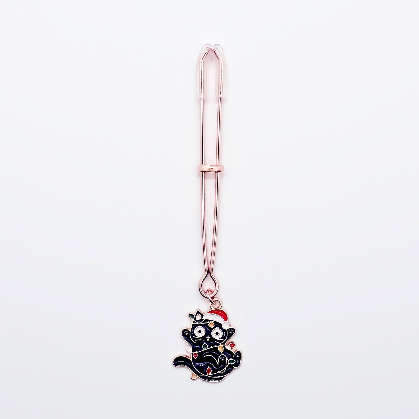 Rose Gold Tweezer Clit Clamp with Black Kitten Wrapped in Christmas Lights wearing a Santa Hat