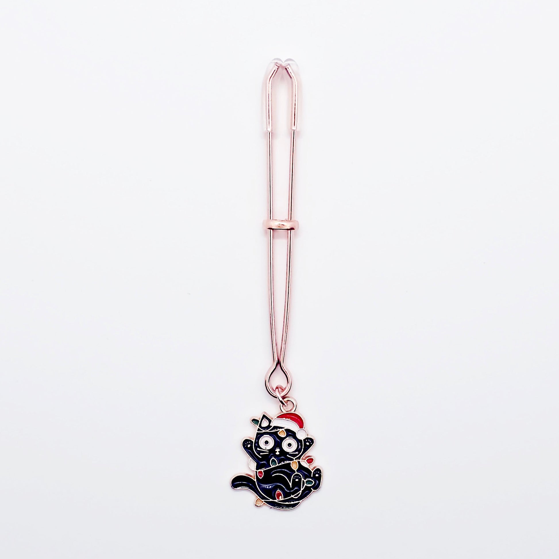 Rose Gold Tweezer Clit Clamp with Black Kitten Wrapped in Christmas Lights wearing a Santa Hat