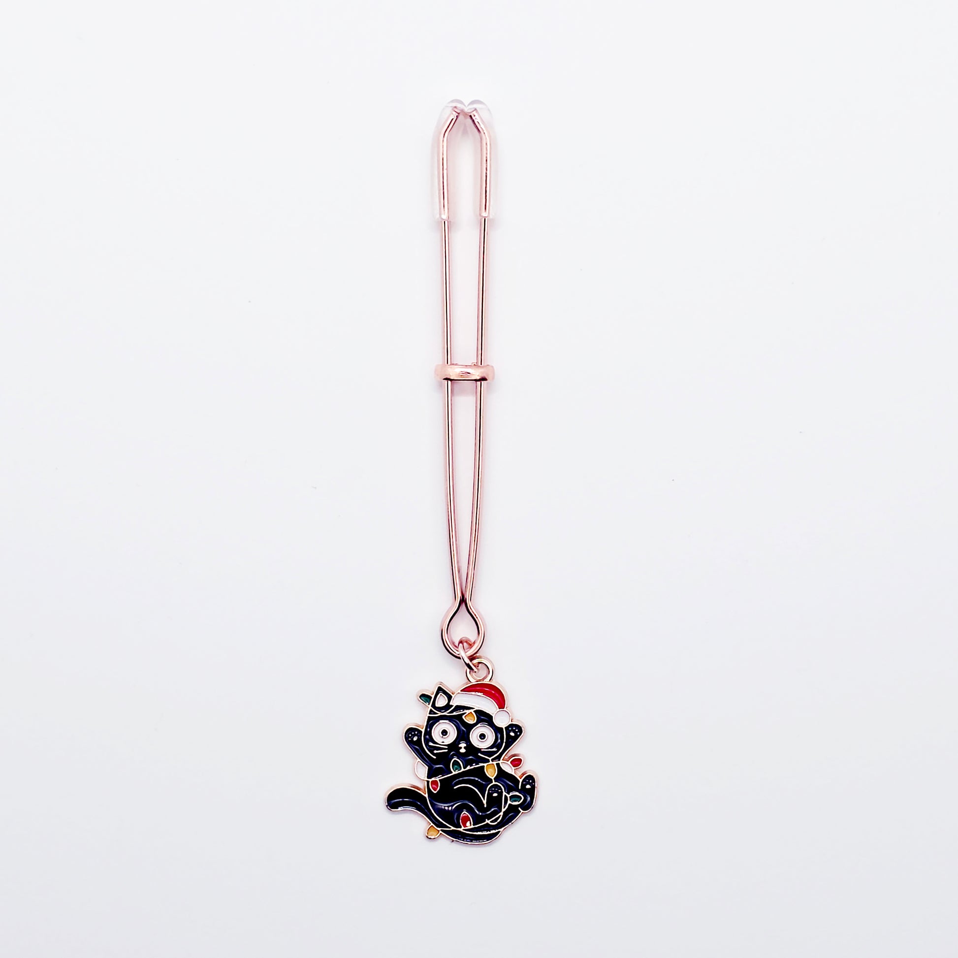 Rose Gold Tweezer Clit Clamp with Black Kitten Wrapped in Christmas Lights wearing a Santa Hat