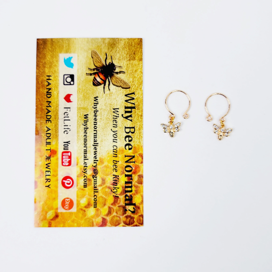 18K Gold Bee Non-Piercing Nipple Rings next to business card